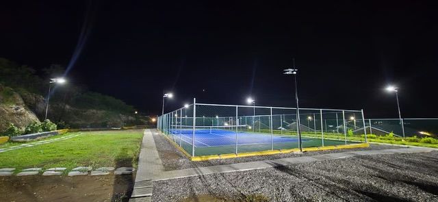 Floodlit tennis court at night